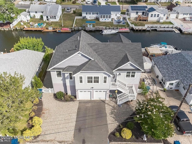 birds eye view of property featuring a water view and a residential view