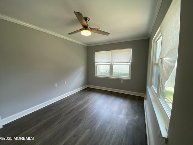 spare room with baseboards, ornamental molding, dark wood finished floors, and ceiling fan