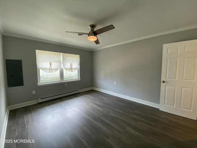 spare room featuring dark wood-type flooring, ornamental molding, electric panel, and baseboard heating