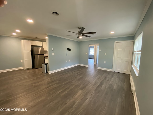 unfurnished living room featuring a ceiling fan, visible vents, and ornamental molding