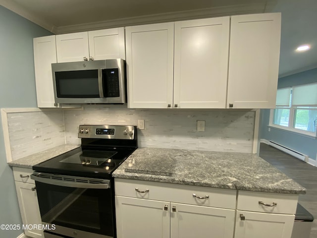 kitchen with tasteful backsplash, white cabinets, and stainless steel appliances