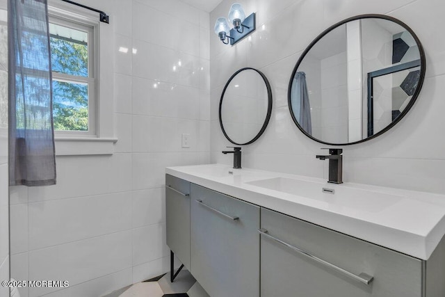 115 Phalanx Rd, Colts Neck, NJ 07722 - full bathroom with double vanity, a sink, and tile walls