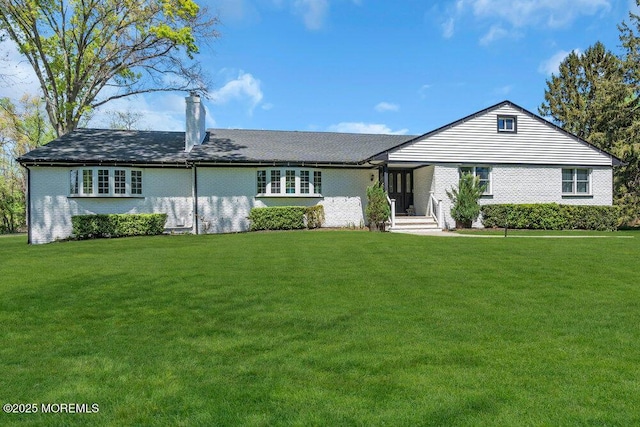 115 Phalanx Rd, Colts Neck, NJ 07722 - ranch-style house with a chimney, a front lawn, and brick siding