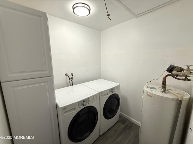 clothes washing area featuring laundry area, washing machine and dryer, baseboards, dark wood-style floors, and water heater