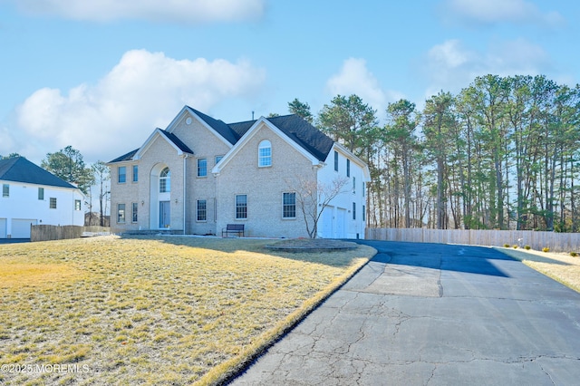 65 Mill Pond Rd, Jackson, NJ 08527 - exterior space featuring fence, a front lawn, and brick siding