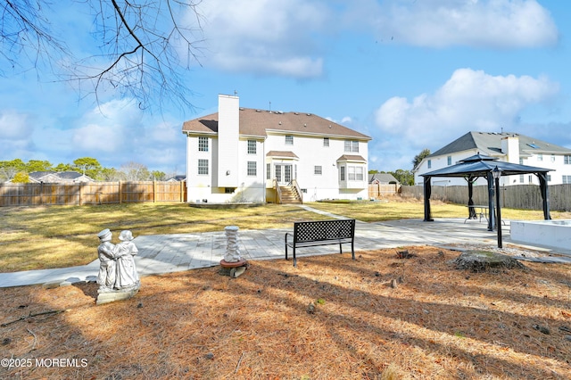 65 Mill Pond Rd, Jackson, NJ 08527 - back of property with a gazebo, a fenced backyard, a chimney, a lawn, and a patio