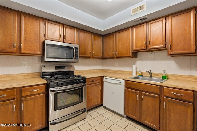 kitchen featuring light countertops, visible vents, appliances with stainless steel finishes, and a sink