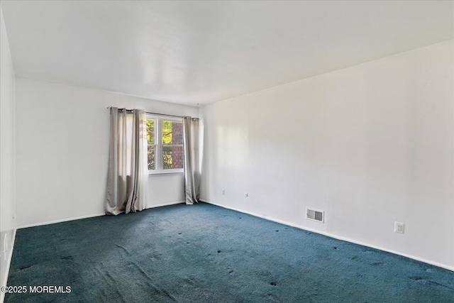 spare room featuring visible vents, baseboards, and carpet floors
