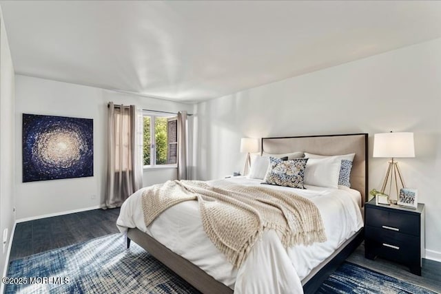 bedroom featuring dark wood-type flooring and baseboards