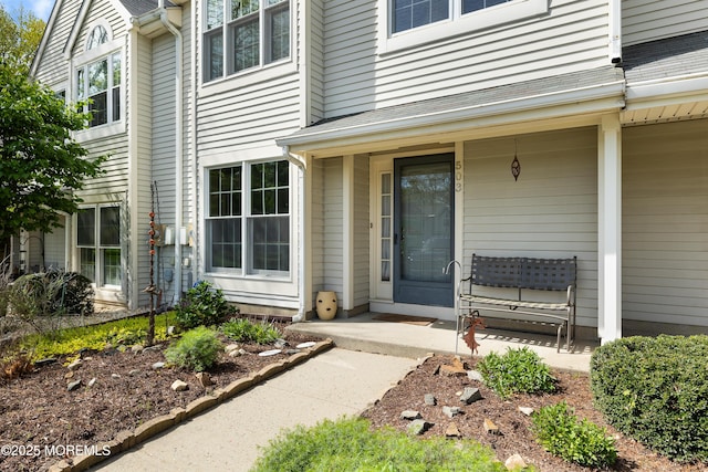 view of exterior entry with covered porch