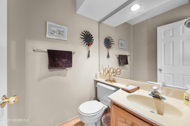 half bathroom with toilet and vanity