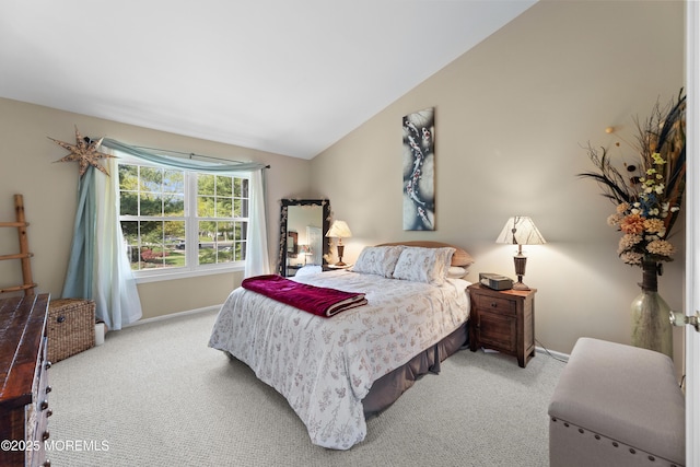 carpeted bedroom featuring baseboards and lofted ceiling