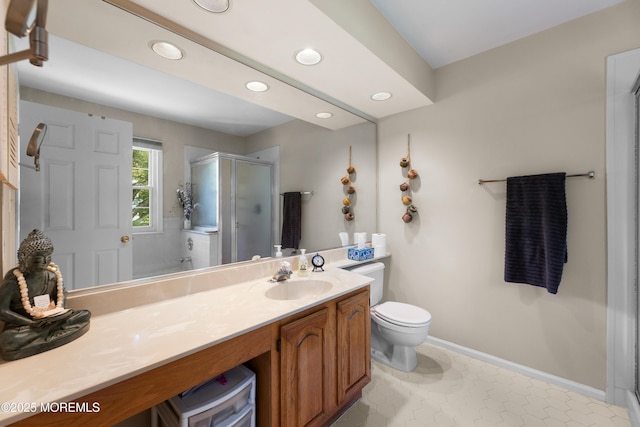 full bath with a stall shower, vanity, baseboards, toilet, and recessed lighting