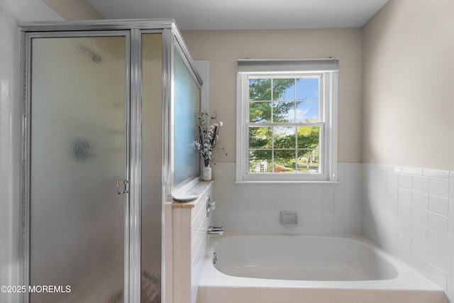 full bath with a garden tub and a stall shower