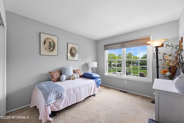 carpeted bedroom with baseboards and visible vents