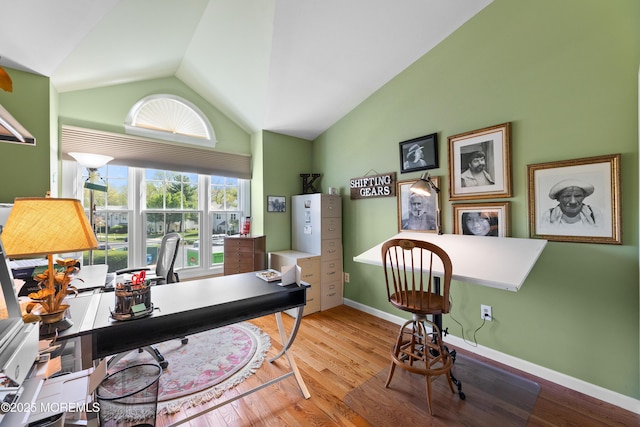 home office featuring baseboards, vaulted ceiling, and wood finished floors