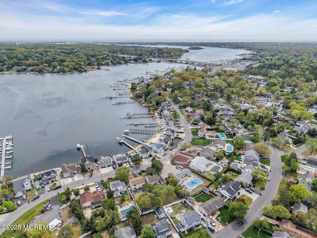 birds eye view of property with a water view and a residential view