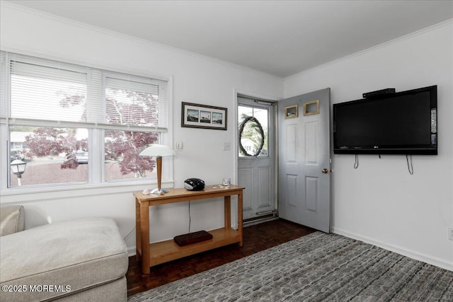 foyer featuring crown molding and baseboards