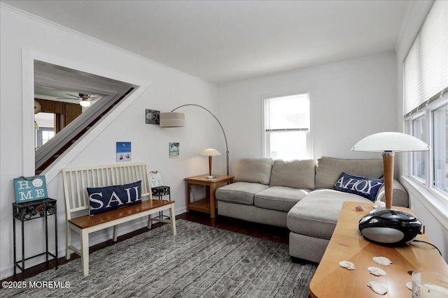 living room with crown molding, ceiling fan, wood finished floors, and a healthy amount of sunlight
