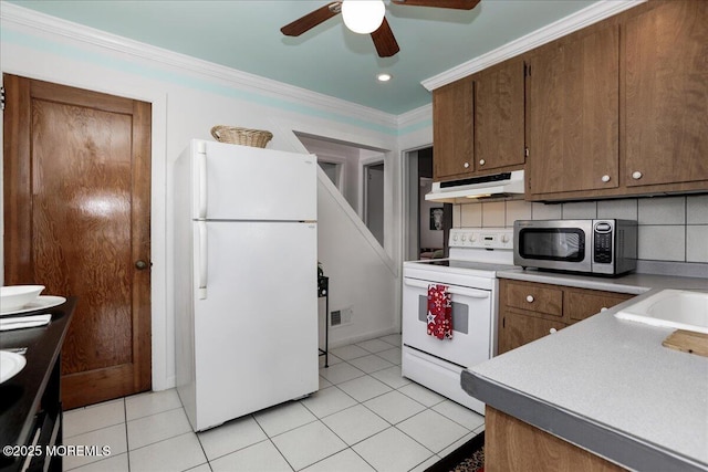 kitchen with ornamental molding, white appliances, under cabinet range hood, a ceiling fan, and light tile patterned floors