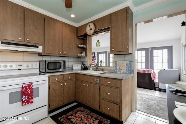 kitchen featuring a sink, stainless steel microwave, white range with electric stovetop, under cabinet range hood, and light tile patterned flooring