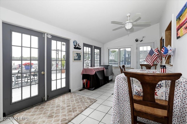 interior space with french doors, a ceiling fan, baseboards, light tile patterned floors, and vaulted ceiling