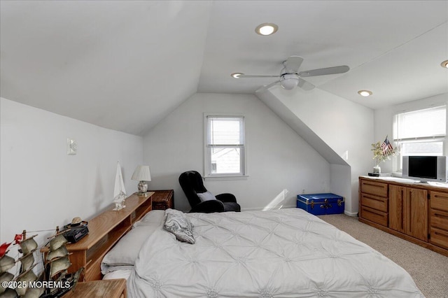 bedroom with ceiling fan, light carpet, and vaulted ceiling