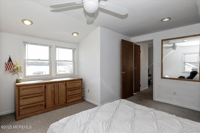 bedroom with recessed lighting, light colored carpet, and multiple windows