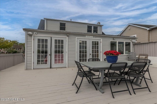 wooden deck with french doors and outdoor dining space