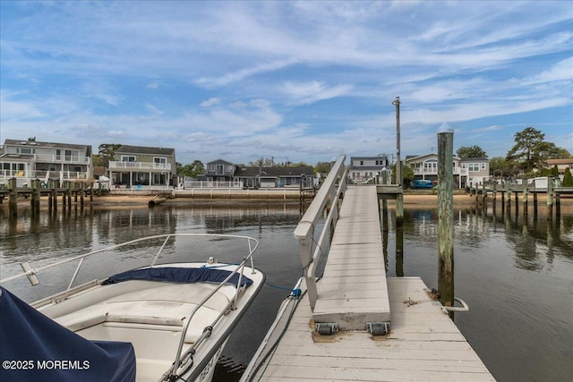 view of dock featuring a water view and a residential view