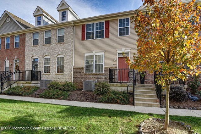multi unit property with brick siding and cooling unit