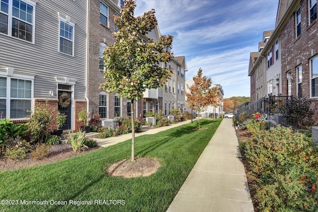 view of community featuring a lawn and a residential view