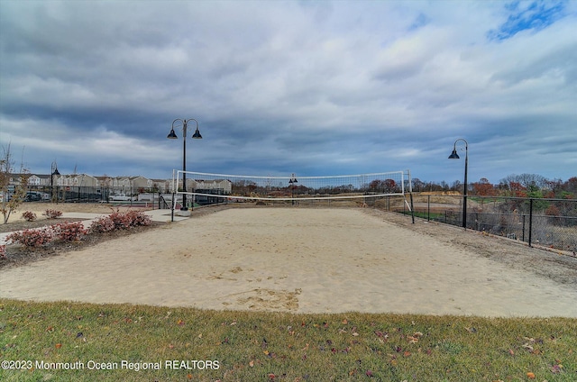 surrounding community with fence and volleyball court
