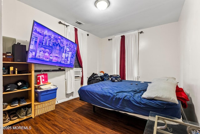 bedroom featuring wood finished floors and baseboards