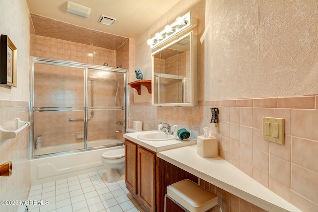 8 Stockport Dr, Toms River, NJ 08757 - full bathroom featuring tile walls, toilet, tile patterned floors, combined bath / shower with glass door, and vanity