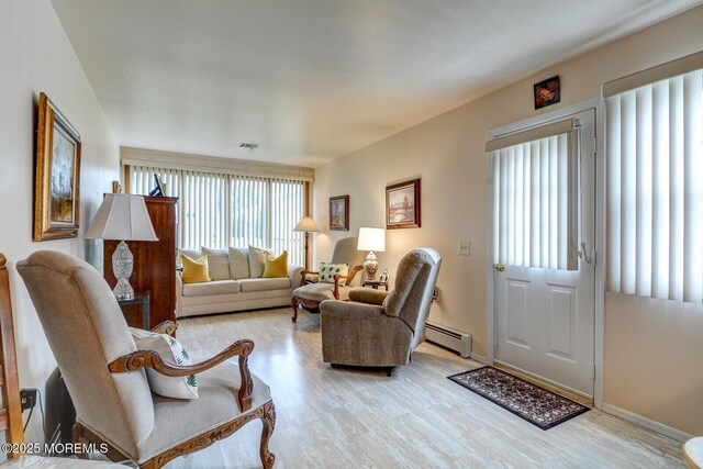 8 Stockport Dr, Toms River, NJ 08757 - living area featuring a baseboard radiator, wood finished floors, and baseboards