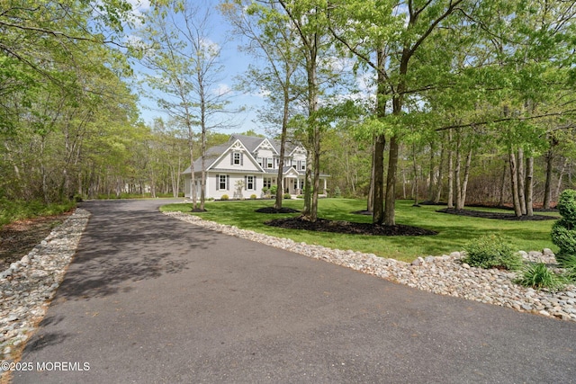 view of front of home featuring driveway and a front lawn
