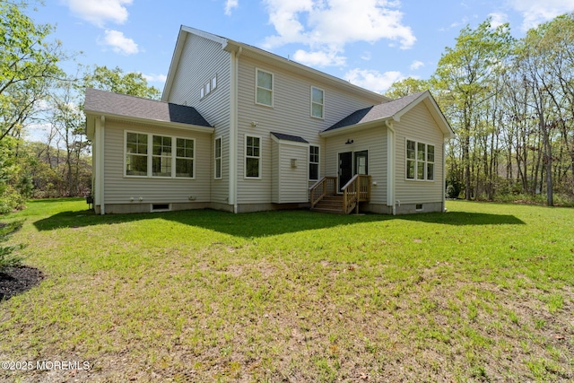 back of house with a lawn and crawl space