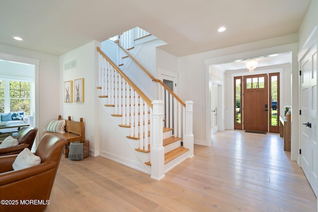 entrance foyer with light wood finished floors, stairs, recessed lighting, and baseboards