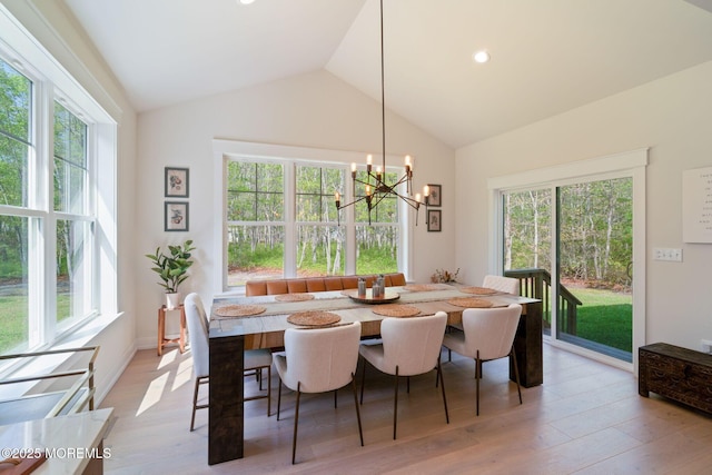 dining room featuring vaulted ceiling, plenty of natural light, light wood finished floors, a chandelier, and recessed lighting