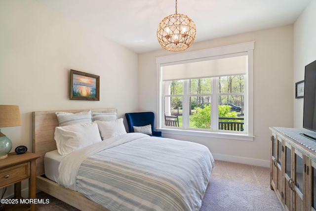 bedroom with light carpet, baseboards, and a chandelier