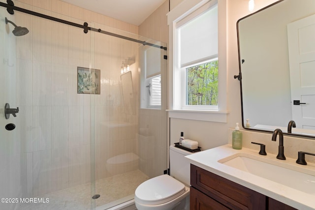 full bathroom with a stall shower, toilet, and vanity