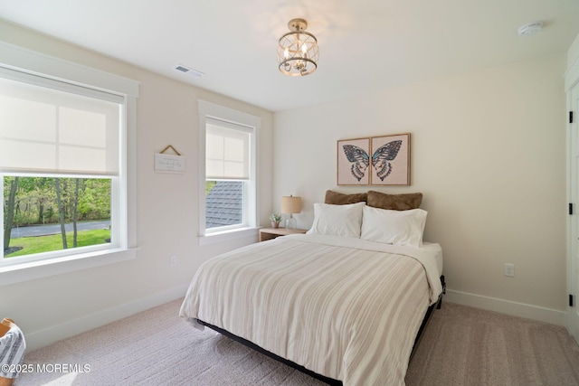 bedroom featuring baseboards, carpet floors, and a chandelier