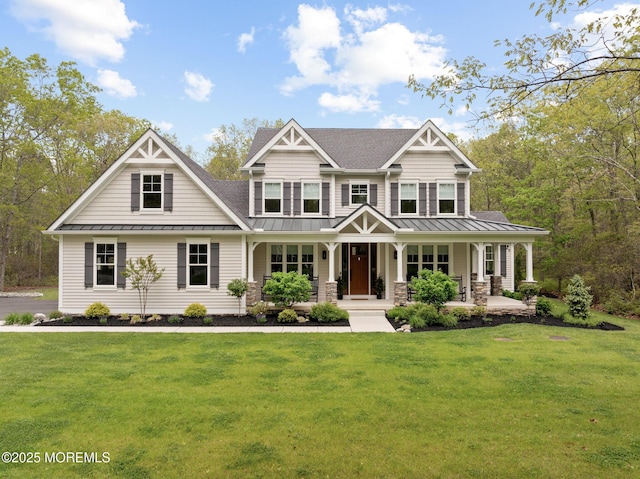 craftsman house with a standing seam roof, a shingled roof, a front yard, and a porch