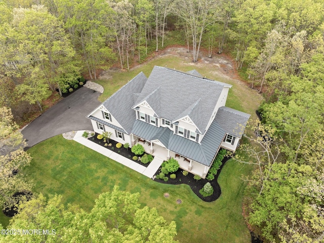 aerial view of property and surrounding area with a forest