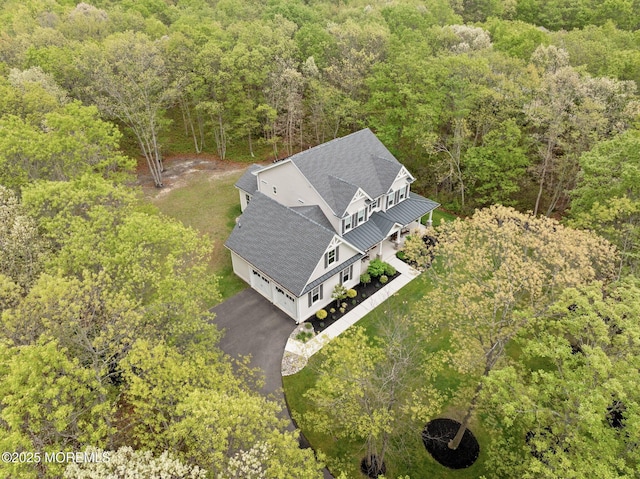 view of subject property with a heavily wooded area