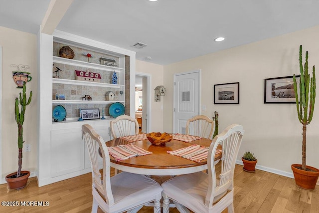 dining area with light wood-style floors, recessed lighting, baseboards, and visible vents