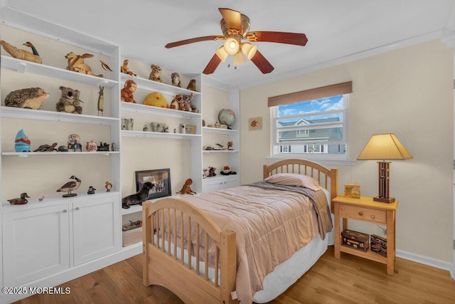 bedroom with crown molding, baseboards, ceiling fan, and light wood-type flooring