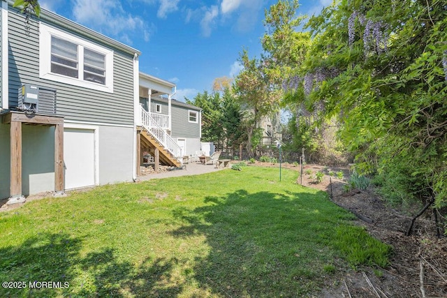 view of yard featuring fence, a patio area, and stairway