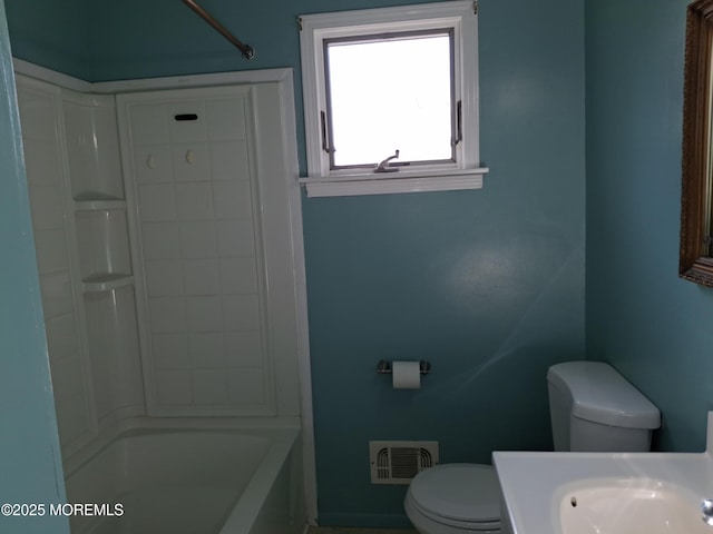 bathroom featuring toilet, visible vents, shower / washtub combination, and vanity